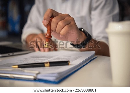Contract law or paper work business and finance document rubber stamp. For official and legal contracts and agreements, financial statements, investment contracts, real estate documents. Royalty-Free Stock Photo #2263088801