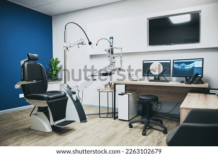 Optometry, empty room and equipment for vision test for eye care in a optical clinic or store. Optic healthcare, ophthalmology and computers, technology or machines in optometrist consultation office Royalty-Free Stock Photo #2263102679