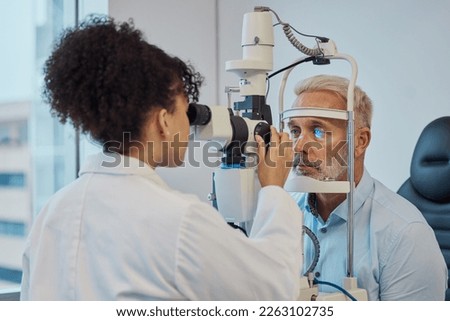 Vision, eye exam and healthcare with a doctor woman or optometrist testing the eyes of a man patient in a clinic. Hospital, medical or consulting with a female eyesight specialist and senior male Royalty-Free Stock Photo #2263102735