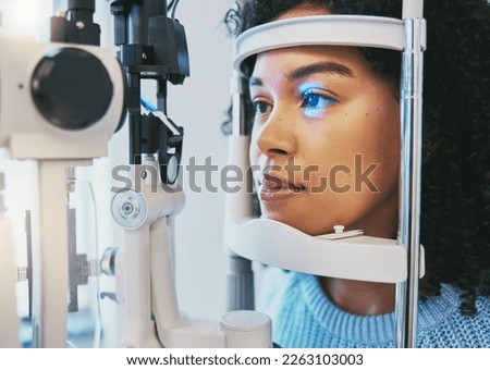Ophthalmology, medical and eye exam with black woman and consulting for vision, healthcare and glaucoma check. Laser, light and innovation with face of patient and machine for scanning and optometry Royalty-Free Stock Photo #2263103003