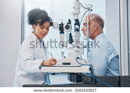 Vision, eye exam and writing with a doctor woman or optometrist testing the eyes of a man patient in a clinic. Hospital, medical or consulting with a female eyesight specialist and senior male Royalty-Free Stock Photo #2263103017