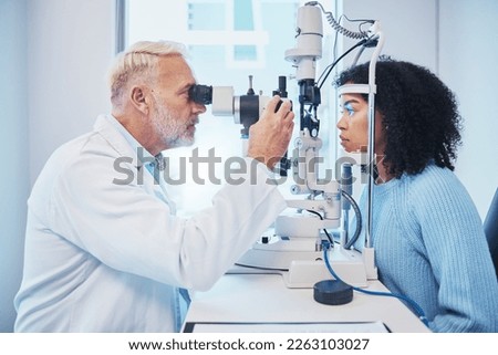 Eye exam, consulting and laser with doctor and black woman for healthcare, ophthalmology and medical. Glaucoma, lens and wellness with patient and optometrist in clinic for vision, checklist and help Royalty-Free Stock Photo #2263103027