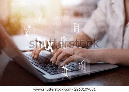 Man using a laptop with TAX REFUND and refund tax of duty taxation business, graphs and chart being demonstrated on the screen media,  tablet pc and selecting tax refund, Saving tax for business
