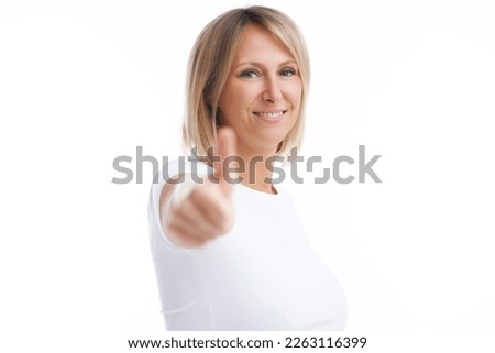 Picture of blonde woman over back isolated background showing ok