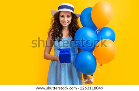 birthday woman smile with gift balloons isolated on yellow. birthday woman