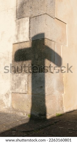 Cross shadow in church corner