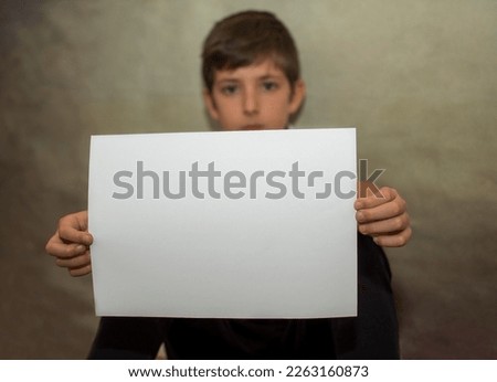 A child holding with his arms a happy message