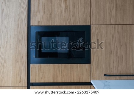 Modern built in microwave oven in the kitchen Royalty-Free Stock Photo #2263175409