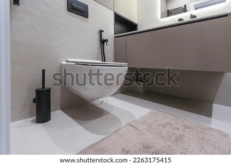 Modern black fittings in the bathroom. black faucets framed in mirror and decorative elements. Royalty-Free Stock Photo #2263175415