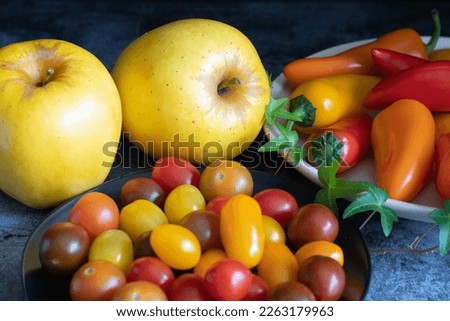 Bright and colorful vegetables and fruit gathered on the kitchen table.