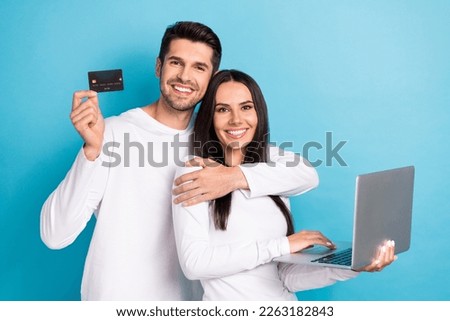 Photo portrait of cute young man woman laptop credit card reservation ecommerce wear trendy white look isolated on blue color background