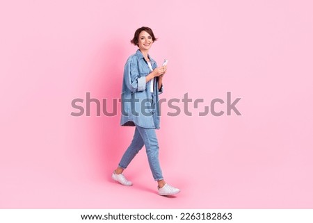 Full length photo of pretty shiny lady dressed denim jacket writing instagram twitter telegram facebook isolated pink color background