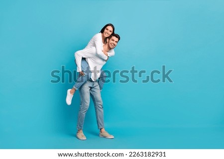Photo of two optimistic satisfied pleasant cute couple people wear white shirts playing having fun isolated on blue color background Royalty-Free Stock Photo #2263182931