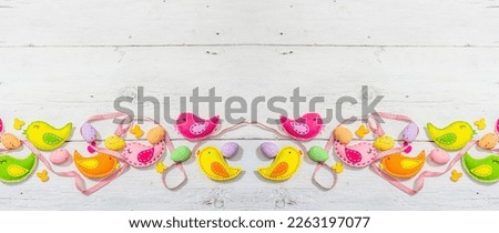 Beautiful Easter background with traditional decor. Decorative eggs, birds and rabbits. Modern hard light, dark shadow, white boards, flat lay, banner format