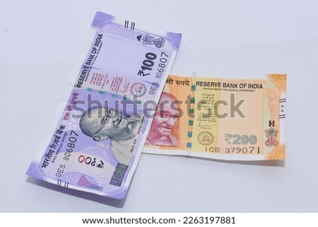  Indian 100 and 200 rupee note close up Royalty-Free Stock Photo #2263197881