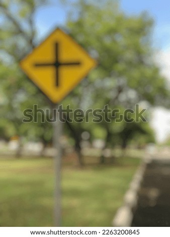 Defocusing abstract background of intersection road sign on the public park