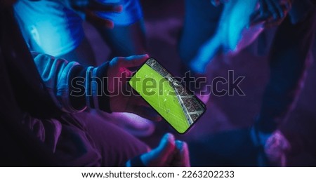 Close Up Smartphone Screen with a Soccer Championship Live Broadcast. Group of People Using the Mobile Phone, Following a Sports Internet Stream, Supporting Their Football Team Royalty-Free Stock Photo #2263202233