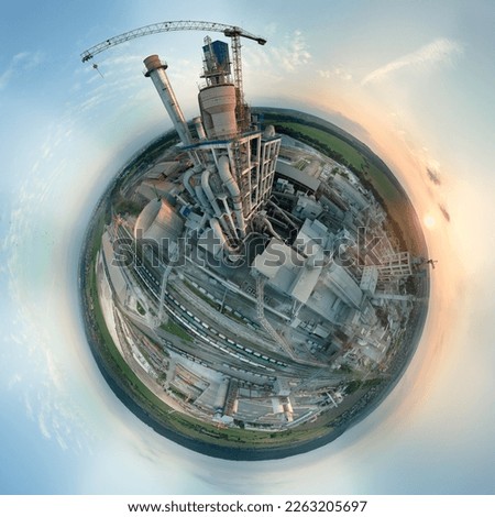 Aerial view from high altitude of little planet earth with cement factory tower with high concrete plant structure at industrial production area at sunset. Manufacturing and global industry concept Royalty-Free Stock Photo #2263205697