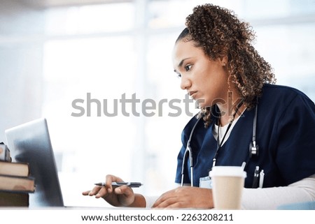 Healthcare, laptop and insurance with a black woman nurse reading information in a hospital for diagnosis. Medical, research and education with a serious female med student working in a clinic Royalty-Free Stock Photo #2263208211