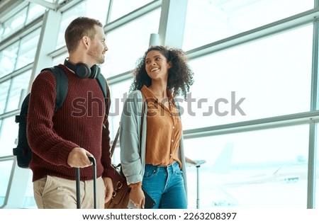 Travel, love and happy with interracial couple in airport for vacation, tourism and departure. International trip, luggage and holiday with man and black woman walking for flight, journey or airline Royalty-Free Stock Photo #2263208397