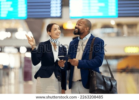 Businessman, airport and service agent pointing traveler to departure, flight time or information. Black male with female passenger assistant helping in travel directions or FAQ for airline traveling Royalty-Free Stock Photo #2263208485