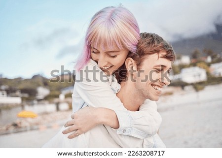 Love, beach and piggy back, couple on date for valentines day, ocean fun and romantic embrace at sunset. Romance, happiness and smile, gen z woman and man on tropical valentine holiday in Indonesia. Royalty-Free Stock Photo #2263208717