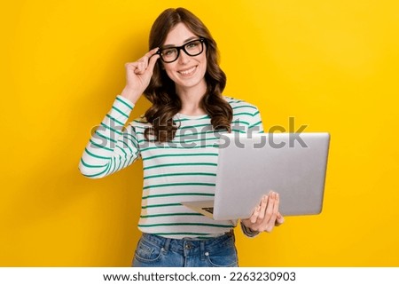Photo of confident satisfied business management worker optimistic woman hold laptop touch glasses remote job isolated on yellow color background