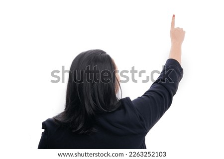 Adult businesswoman in formalwear with back to camera touching transparent display as blank copyspace using index finger isolated on white studio background