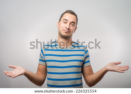 Young man throws up his hands in surprise