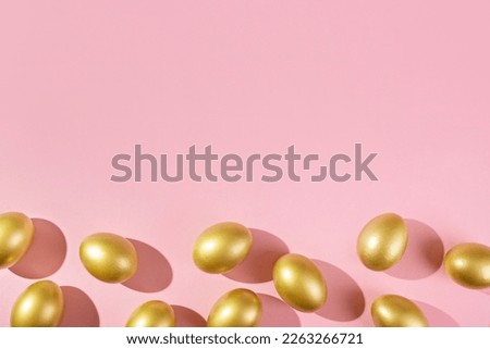 Easter template with golden egg border. Eggs painted gold on pink background. Easter concept with copy space for text. Flat lay style minimalistic design.