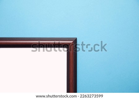 Empty diploma or certificate frame on the blue background.