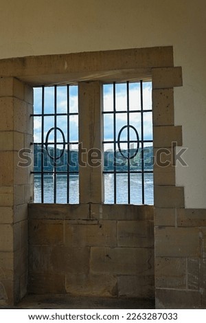 View through a barred window at the Staudam on the Eder lake in Germany