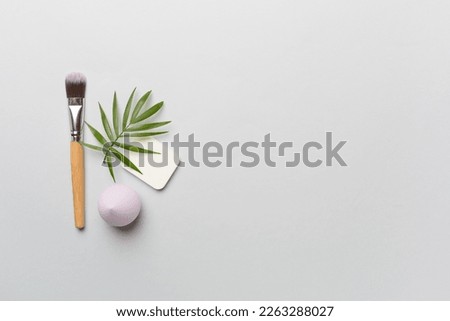 Make up brush and sponge on color background, top view