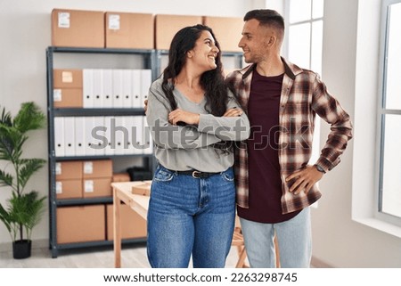 Man and woman ecommerce bussines workers standing together at office