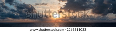 Dramatic Colorful Sunset Sky over Mediterranean Sea. Clouds with Sunrays. Cloudscape Nature Background. Panorama Royalty-Free Stock Photo #2263311033