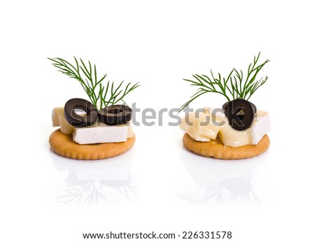 Canape with Brie Cheese and Olives isolated on white