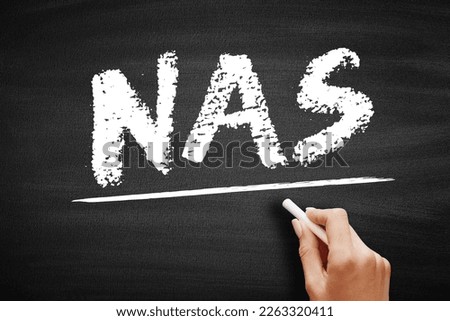 NAS Network-Attached Storage - file-level computer data storage server connected to a computer network, acronym text on blackboard