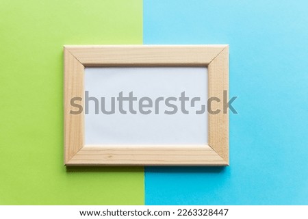 blank wooden mock up frame on green blue background. top view.Freelancer, social media blogger concept. Mock up, copy space.