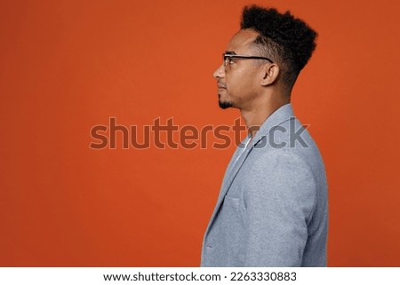 Side profile view young confident smart successful employee business man corporate lawyer wearing classic formal grey suit shirt glasses work in office isolated on plain red orange background studio Royalty-Free Stock Photo #2263330883
