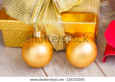 golden  gift box with  christmas decorations close up on wooden background