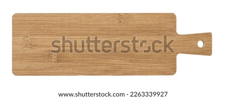 Long serving board cutout. Empty bamboo board with handle for serving food isolated on a white background. Modern kitchen utensil made of wood for food design. Cutting board. Top view. Royalty-Free Stock Photo #2263339927