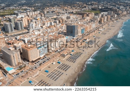 Aerial drone photo of the beautiful beach front of the coastal town of  Fuengirola in Malaga Spain Costa Del Sol, showing the large sandy beach, hotels and apartments 