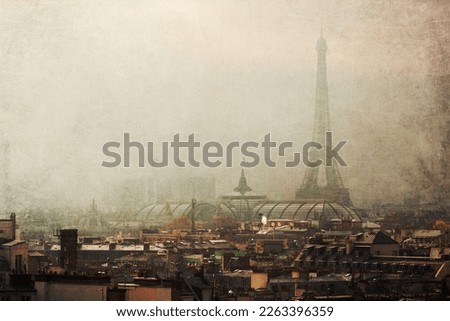 vintage textured picture with a look over roofs of Paris, France, to the famous Eiffel Tower