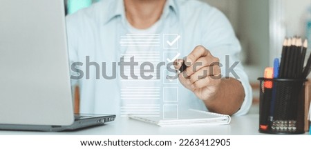 Document management system. Assessment form, questionnaire, checklist, clipboard task management. Businessman tick correct sign mark for document approve, Take an assessment, evaluation, online exam. Royalty-Free Stock Photo #2263412905
