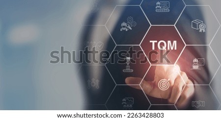 Total quality management (TQM) concept. Touching on smart screen with TQM text on smart background. Management approach to long-term success through customer satisfaction and sustainability. Royalty-Free Stock Photo #2263428803