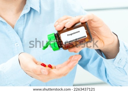 Progesterone Woman Hand holding on open palm with pill tablets medicine for healing Royalty-Free Stock Photo #2263437121