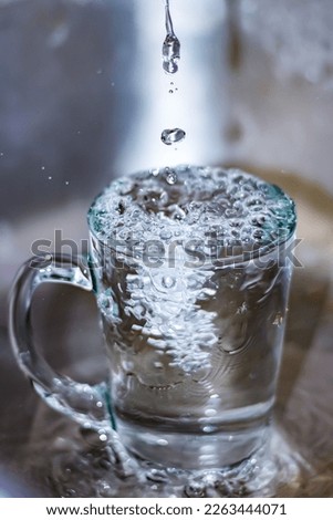The water overflows of the glass.Water cools.