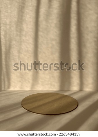 Round podium on beige background. Product promotion. Front view, studio photography.