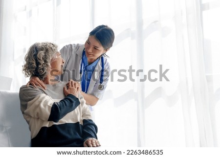 Young asian caretaker with 60s asia elderly woman consulting and encourage, take a history and recommend the right treatment, holding hands and encouraging Royalty-Free Stock Photo #2263486535