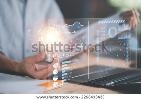 businessman holding a light bulb ,business statistic chart report to analyze and improve corporate strategy ,Financial document management ,Annual budget account updates ,Company growth planning